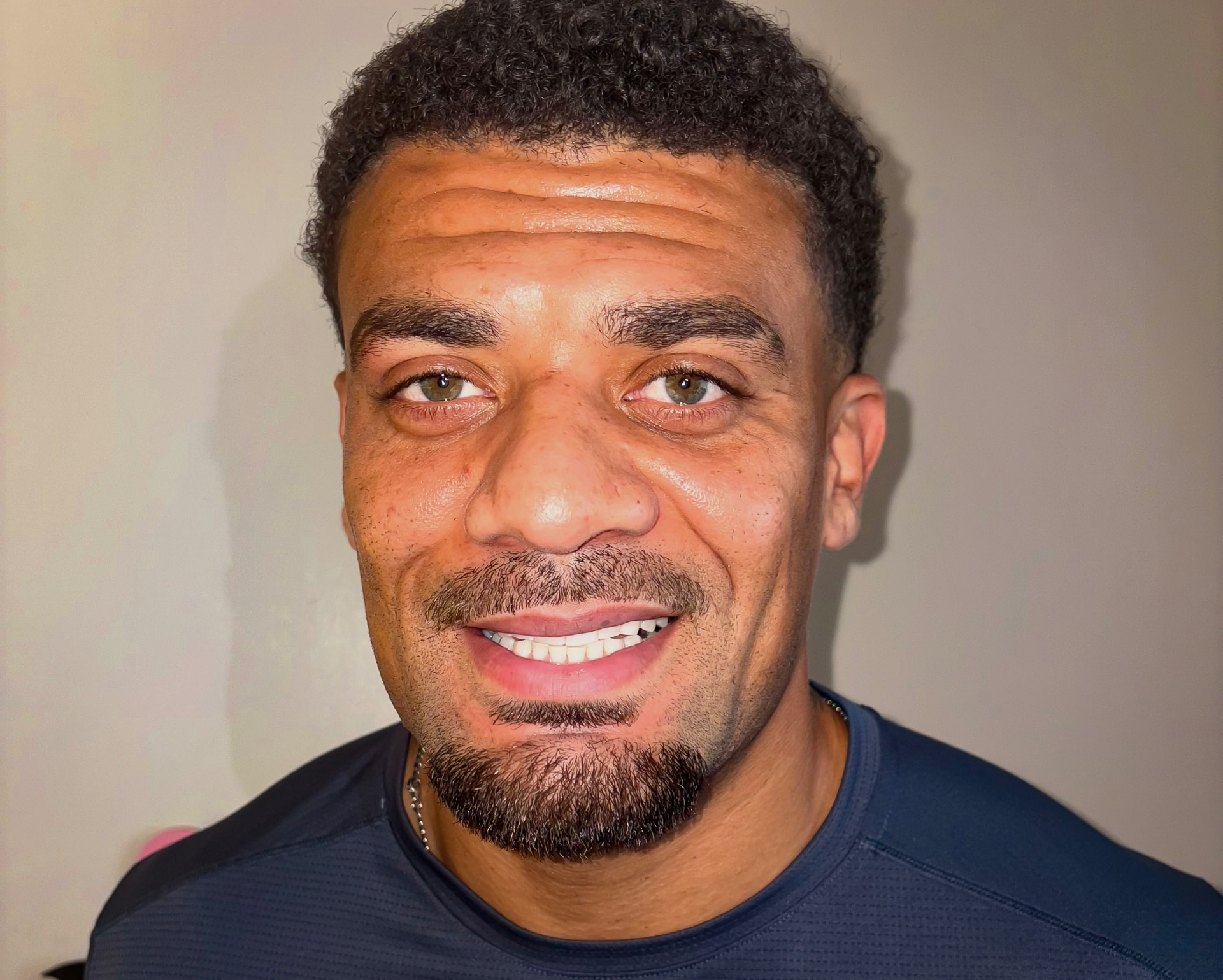 Isaac Philips smiling at Glow Whitez Beauty Studio